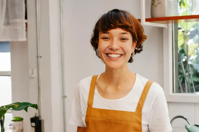 woman wearing an apron smiling